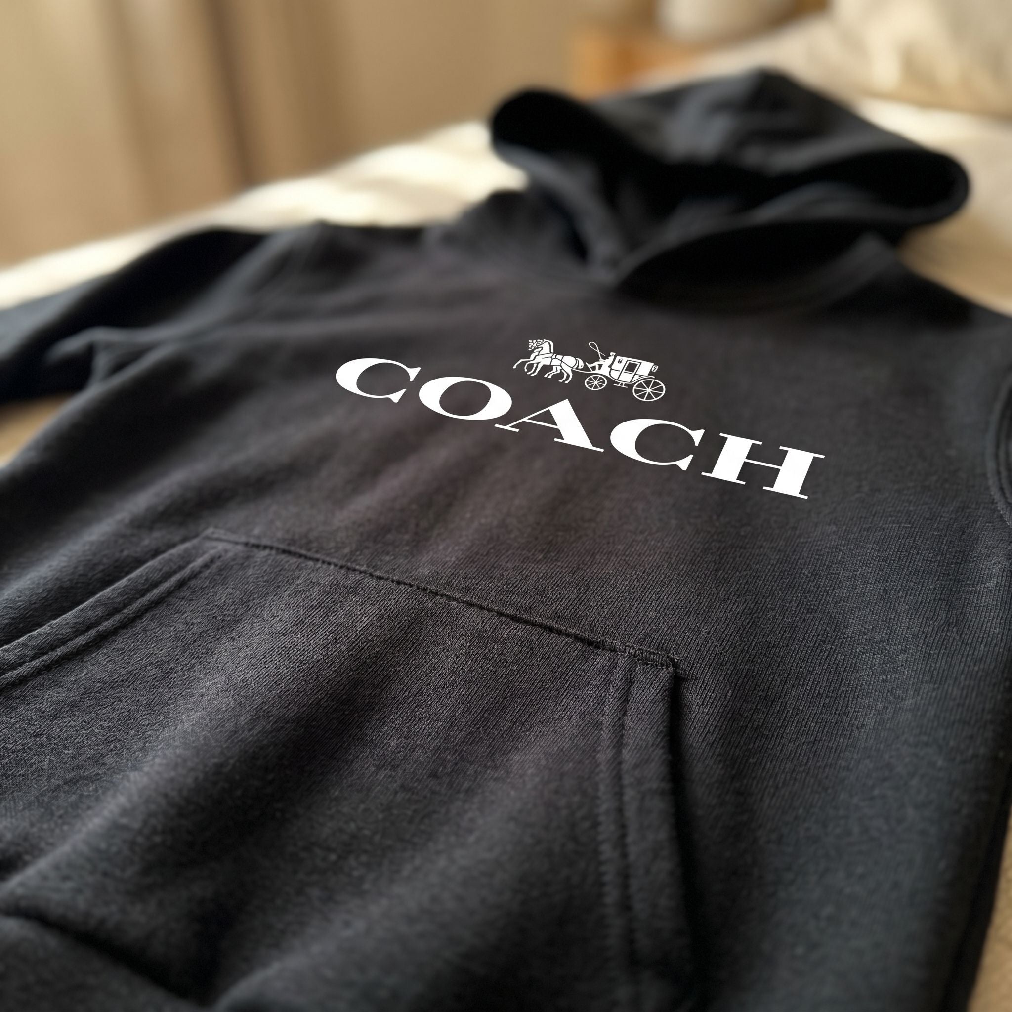 Close-up of youth kids coach pullover hoodie, highlighting soft cotton-polyester knit fabric and subtle color tones under natural daylight.